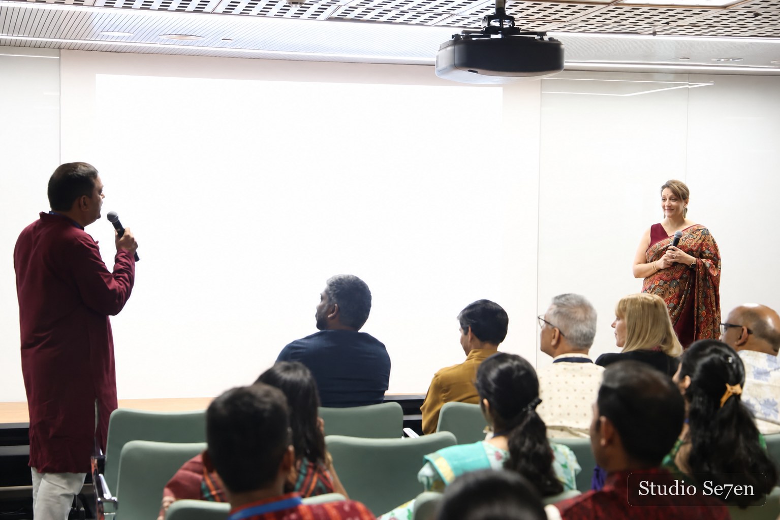 Two speakers exchanging ideas during a corporate event