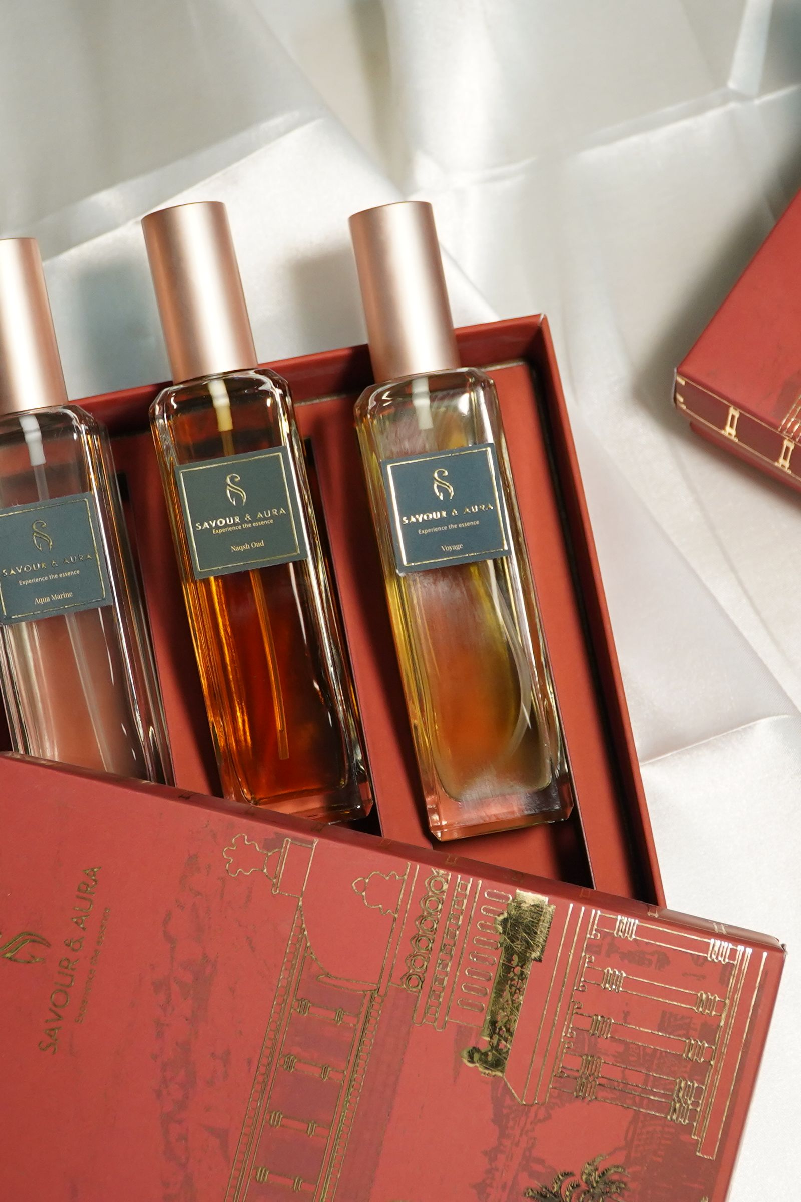 Attar perfume bottles in an open red gift box, photographed in warm natural light