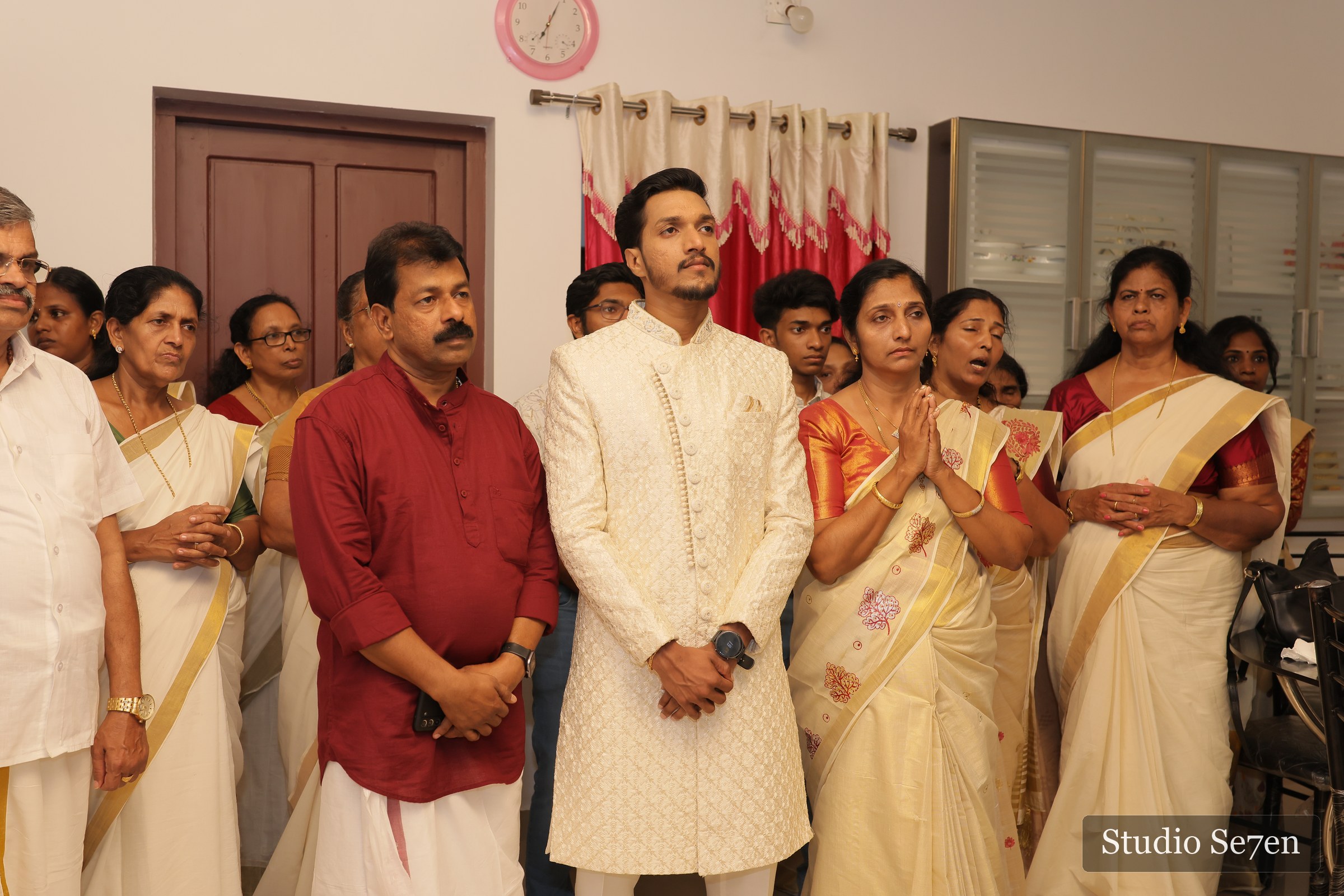 The engaged couple surrounded by family during their celebration