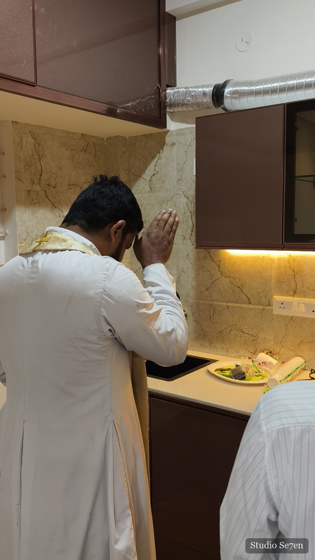 A quiet prayer during the blessing of a new kitchen