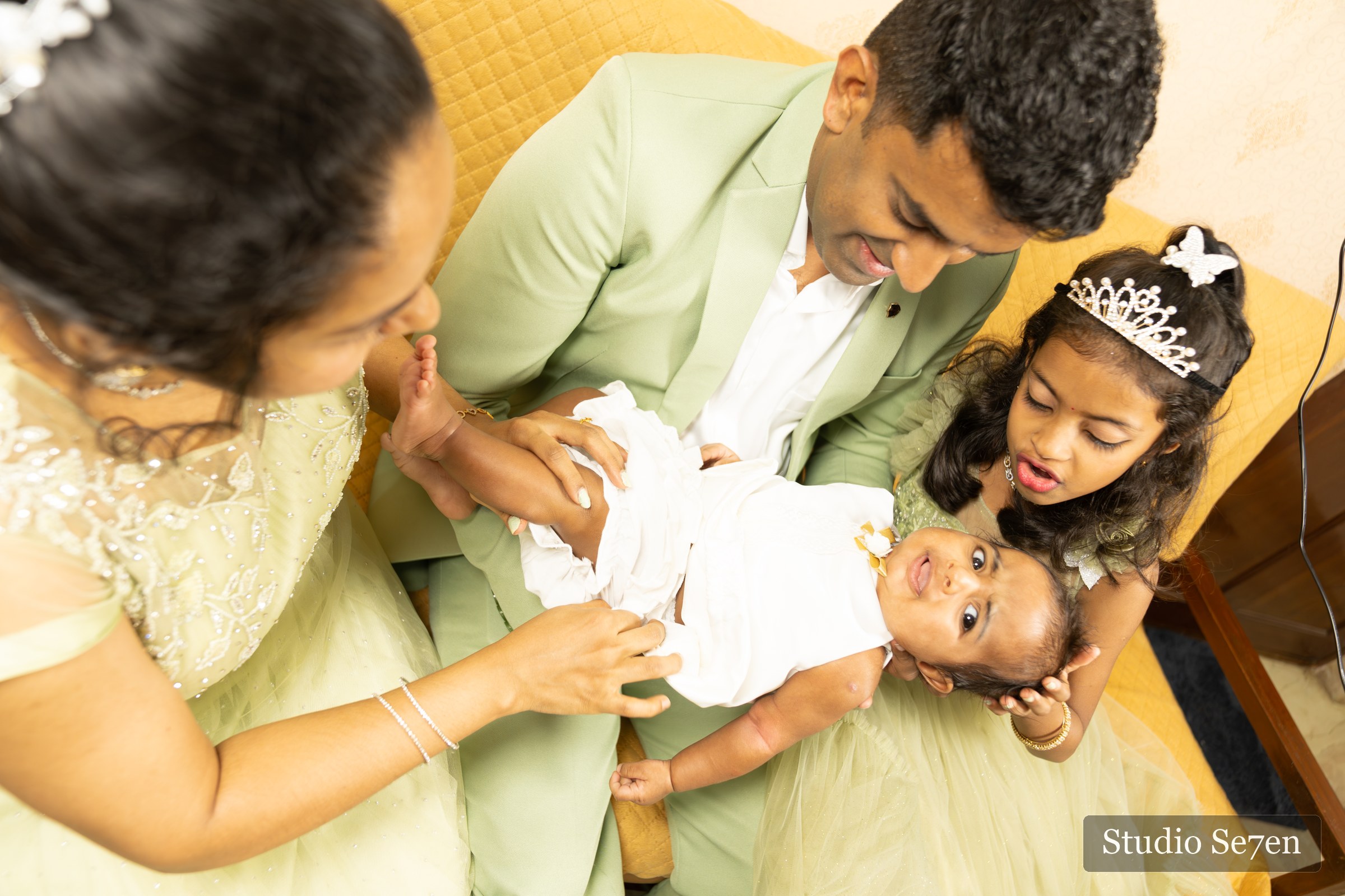 Jazriel sharing a playful moment with his parents and sister before the baptism