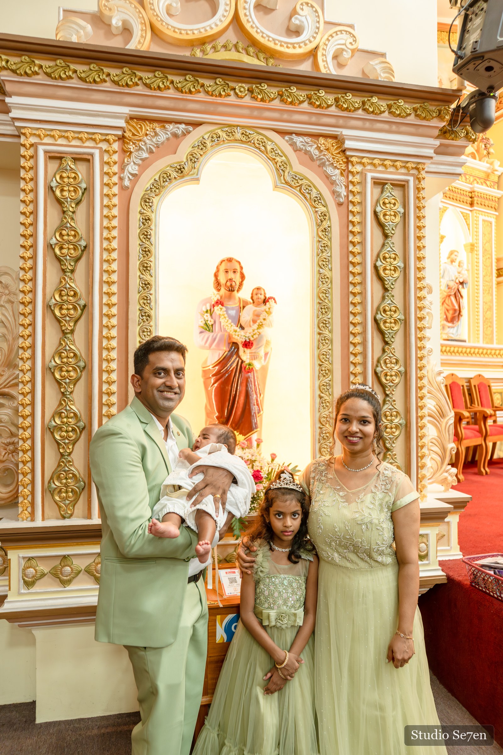 Jazriel with his parents and sister in a family portrait inside the church