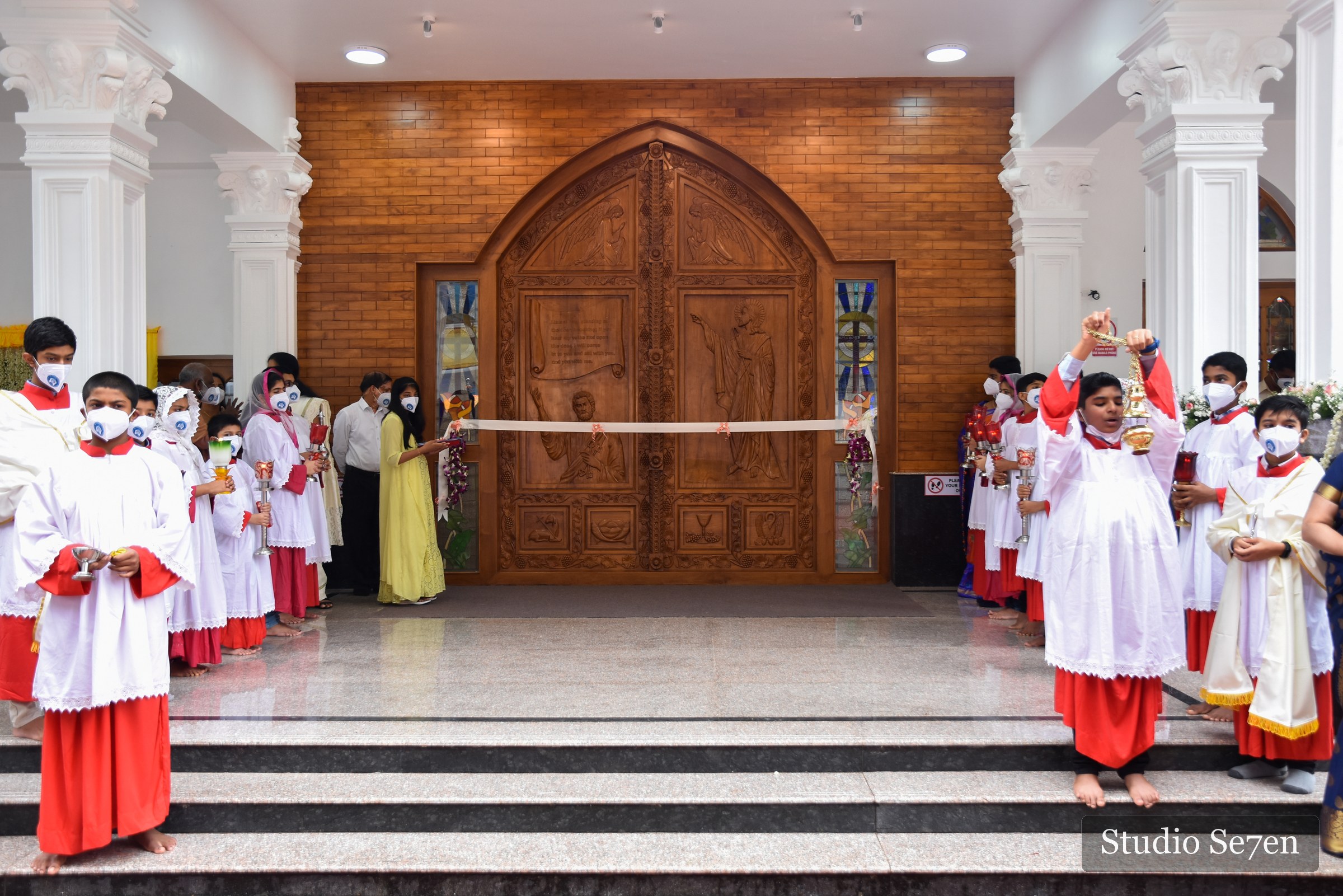 Clergy and altar servers gathered at the church entrance for its consecration