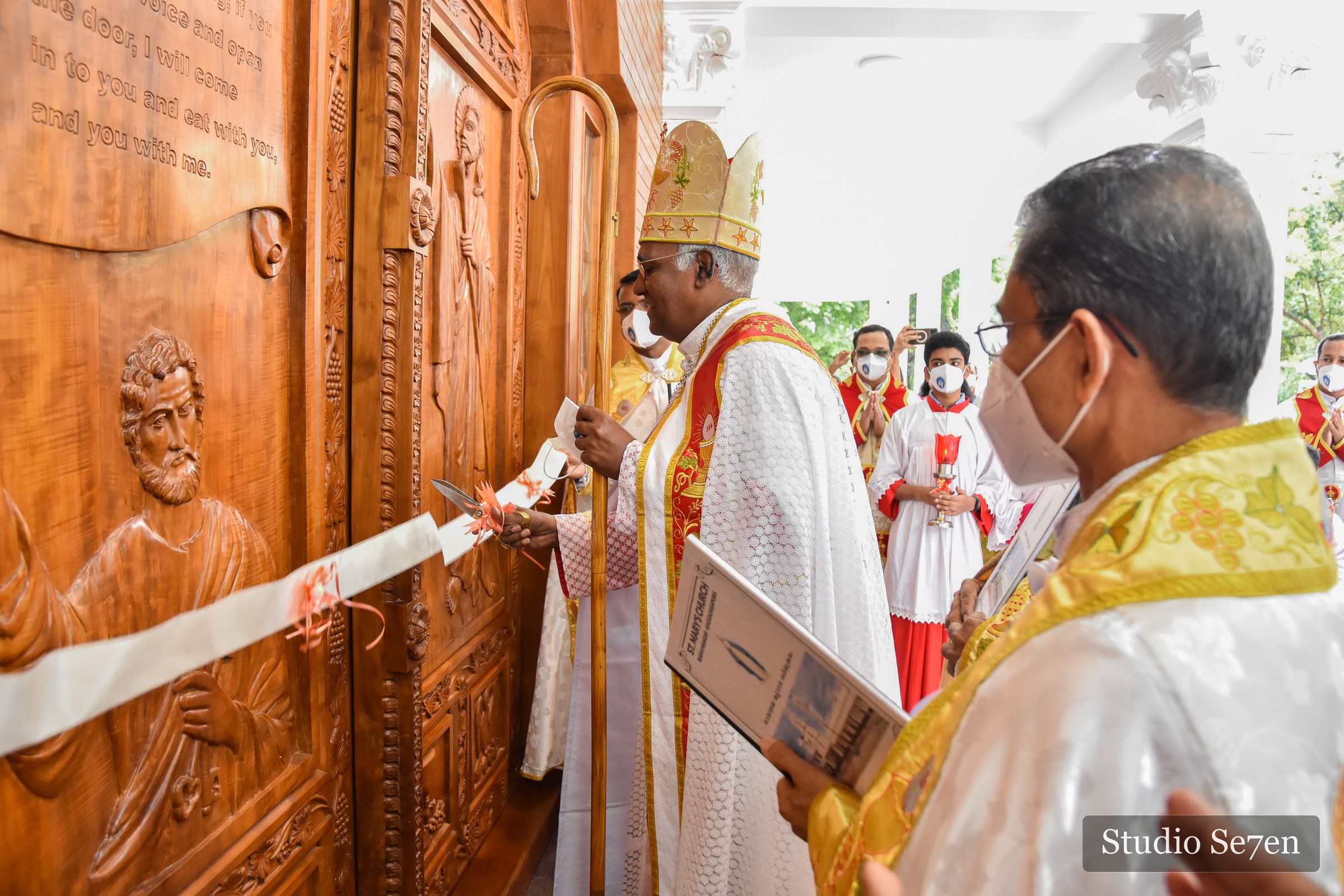 A bishop cutting the ribbon at the church consecration ceremony