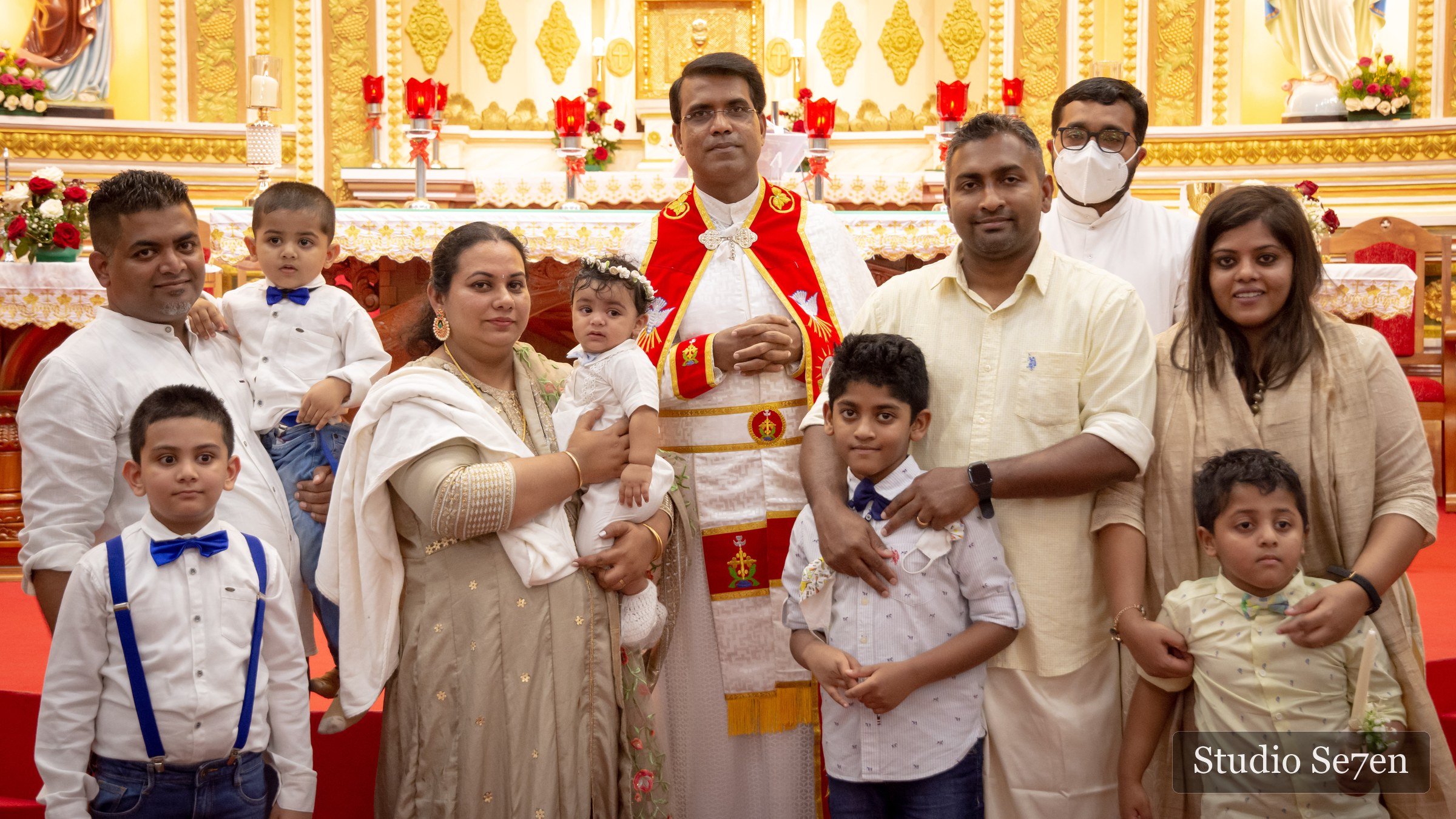 Dave with his family and priest after the baptism ceremony
