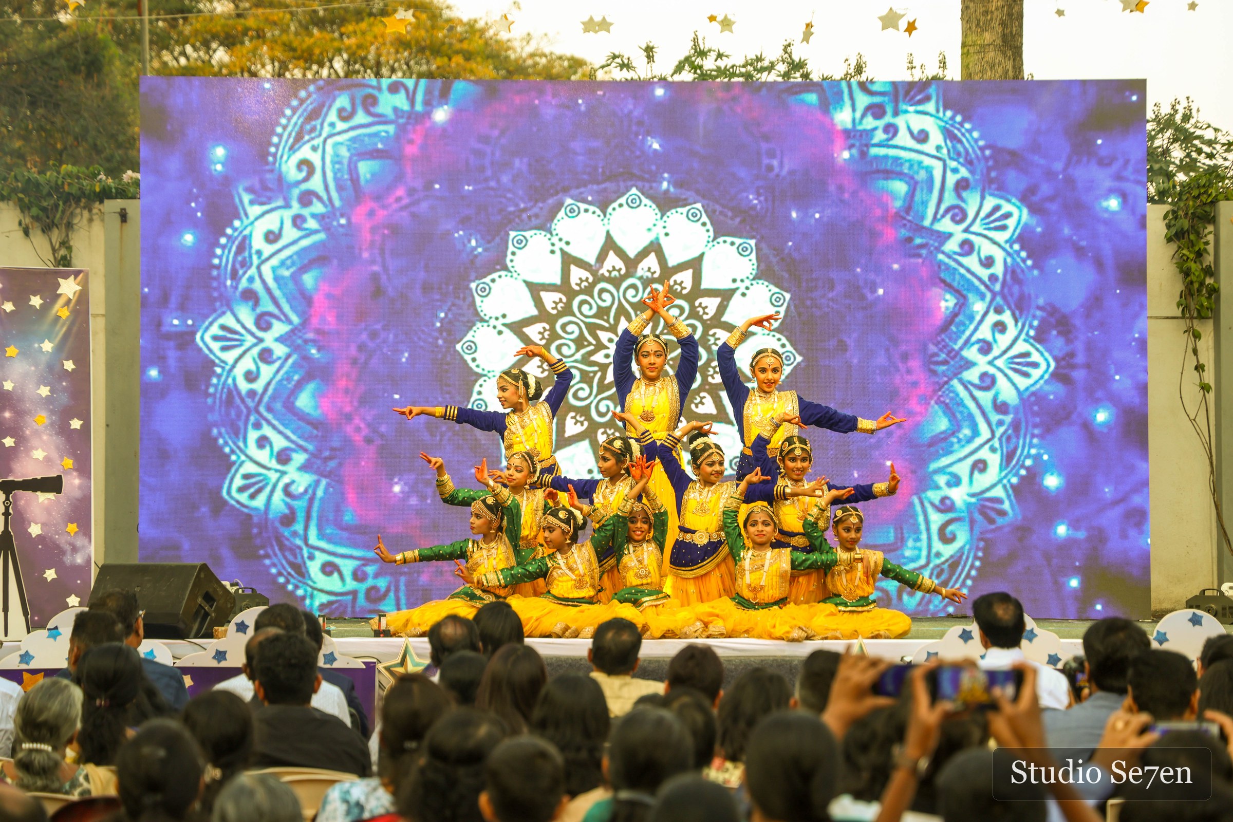 Students presenting a colourful cultural performance on stage