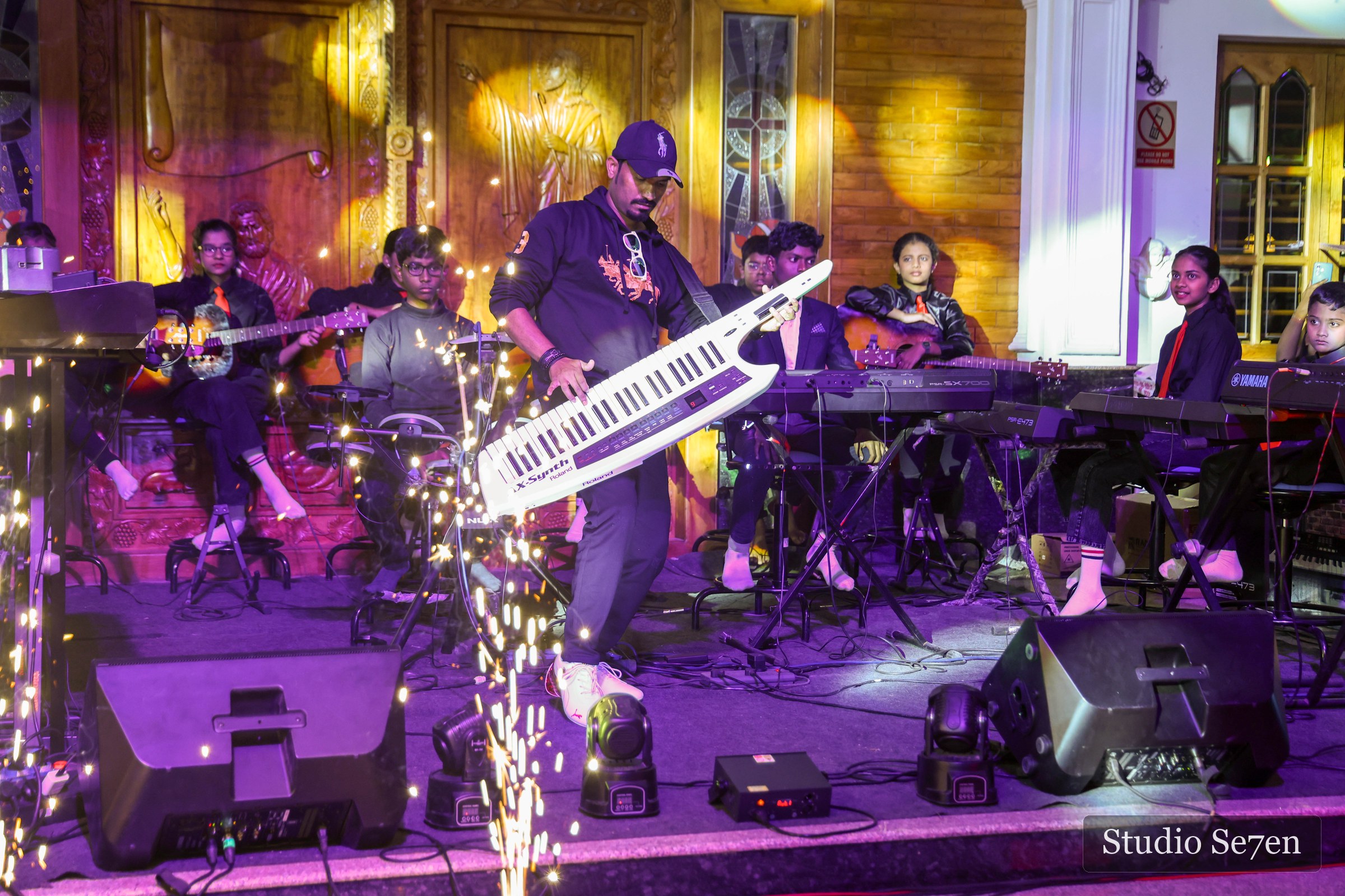 Live musicians performing under dramatic stage lighting