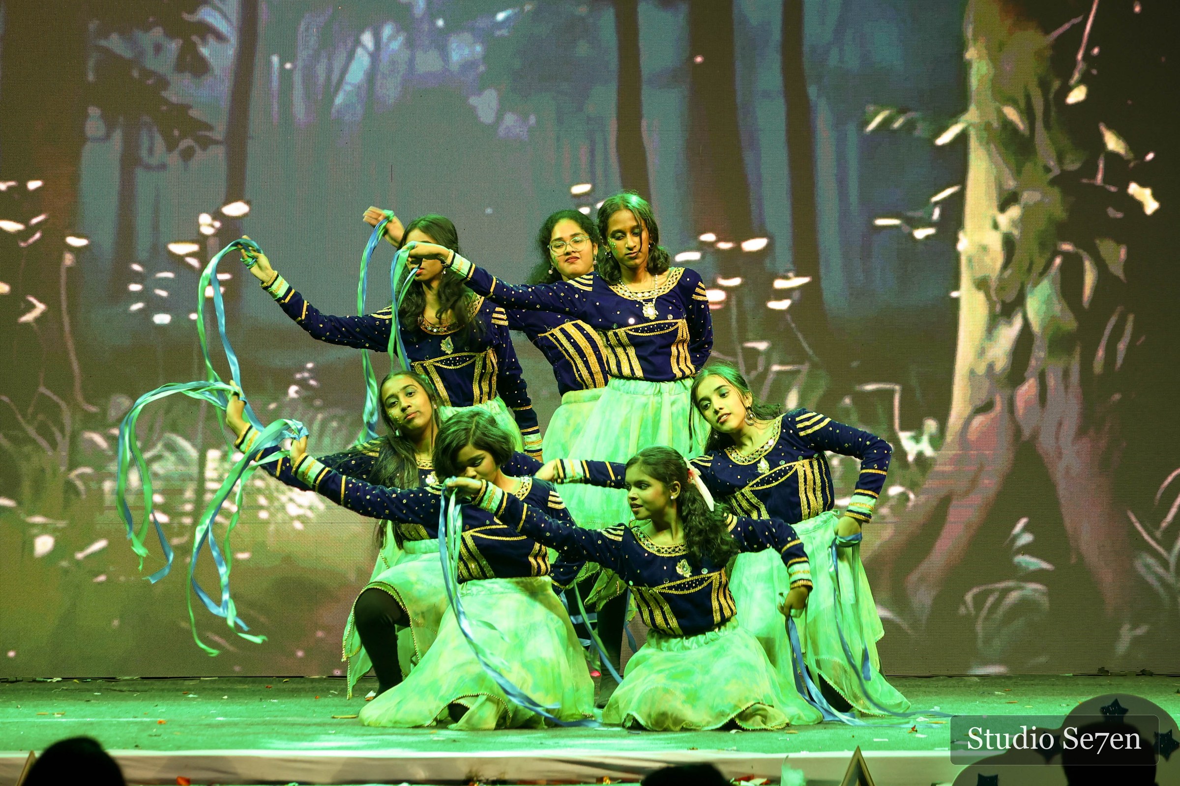 Student dancers holding a dramatic formation with flowing ribbons