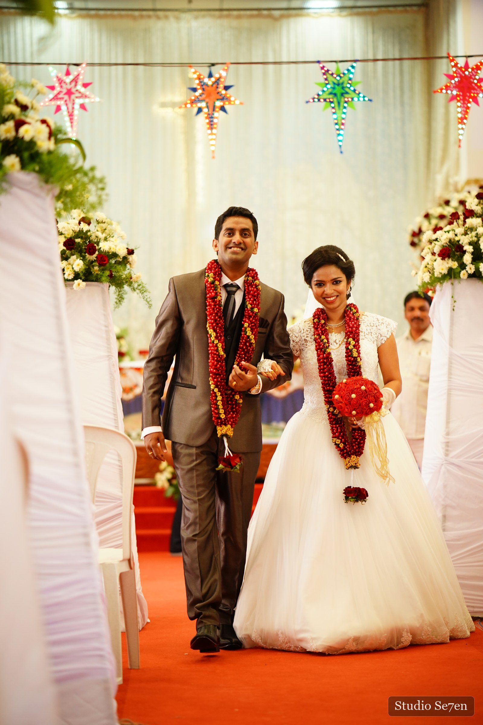 A newly married couple walking together after their church ceremony