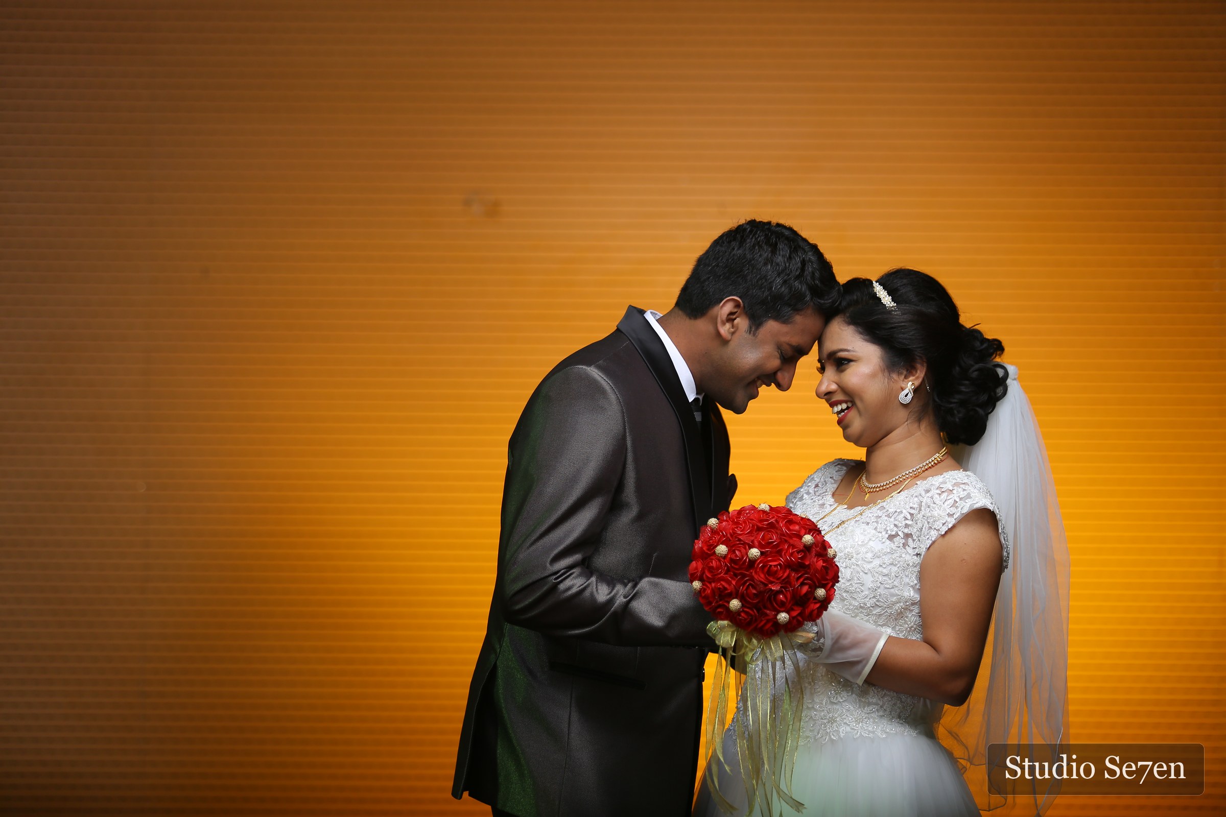 A bride and groom sharing a quiet studio portrait after their wedding