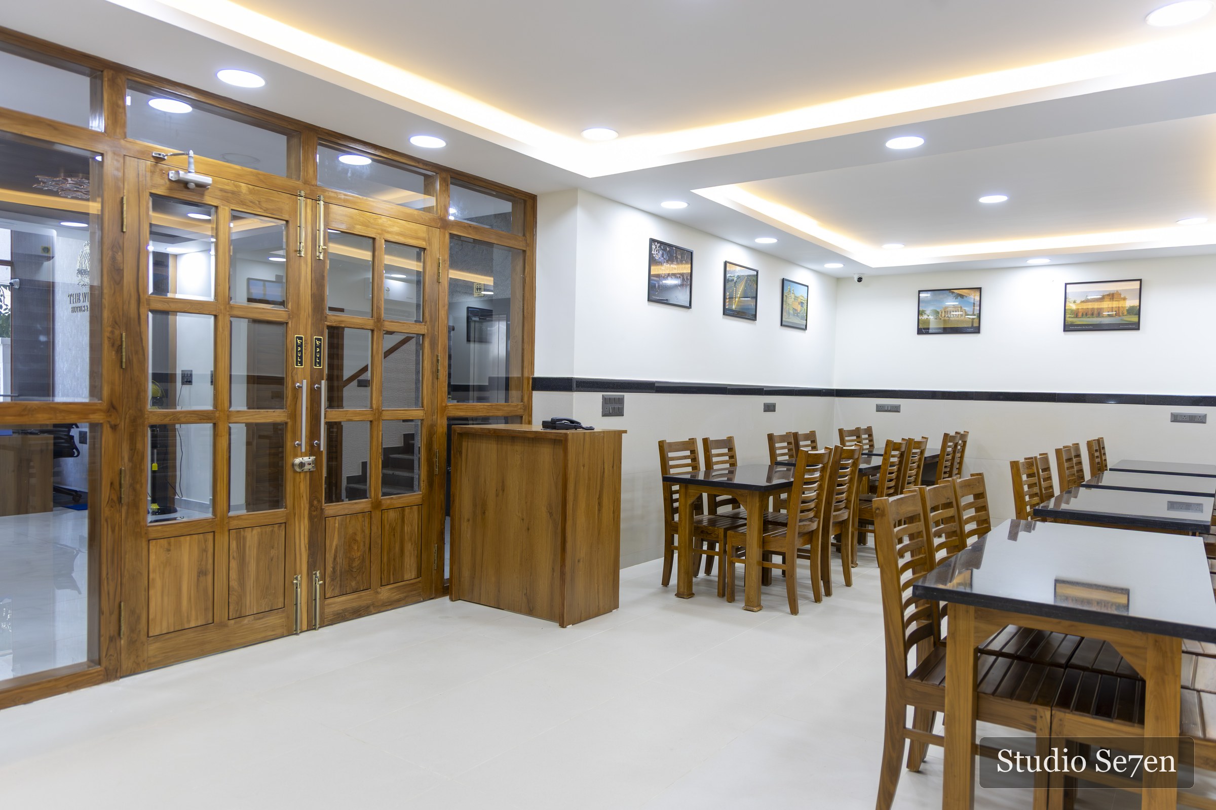 Bright dining room at The Wilsons with neatly arranged wooden tables