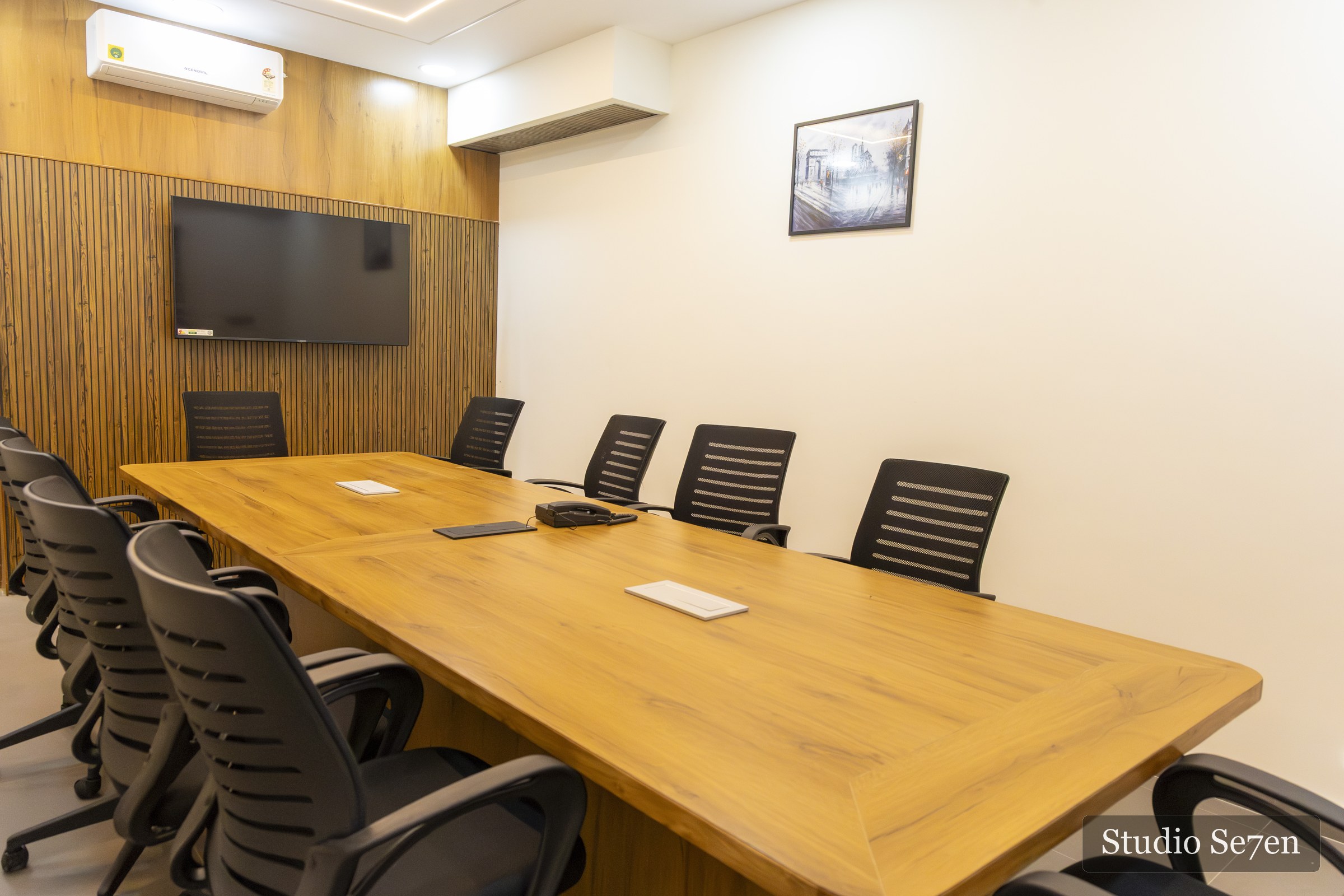 Conference room at The Wilsons with a long wood table and black chairs